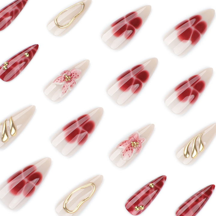 Artful stiletto nails with elegant floral designs and glitter accents Bowlift