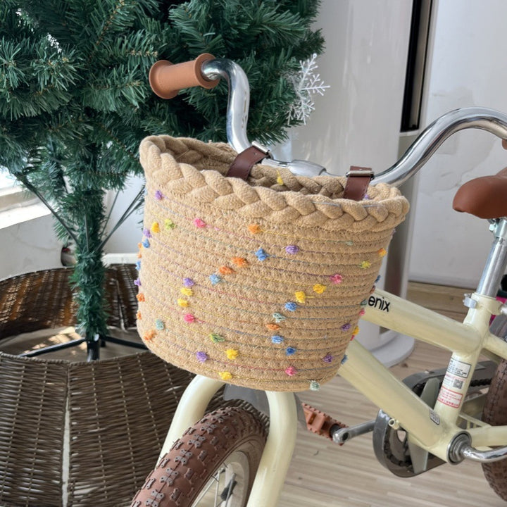 braided rope bike basket with pom pom embellishments and leather handlebar straps Bowlift