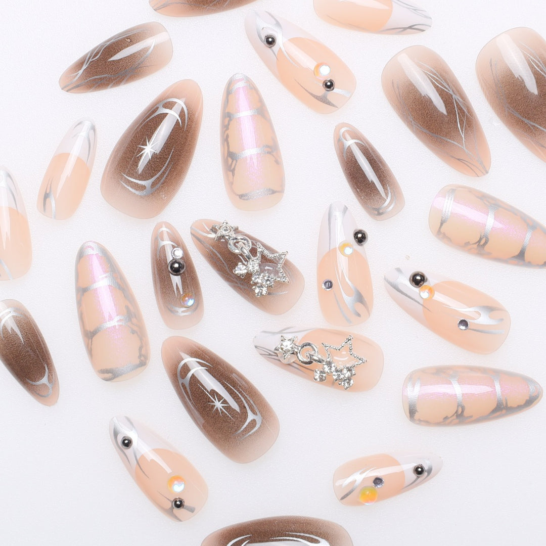Artistic Stiletto Nail Extensions with Metallic Accents Bowlift