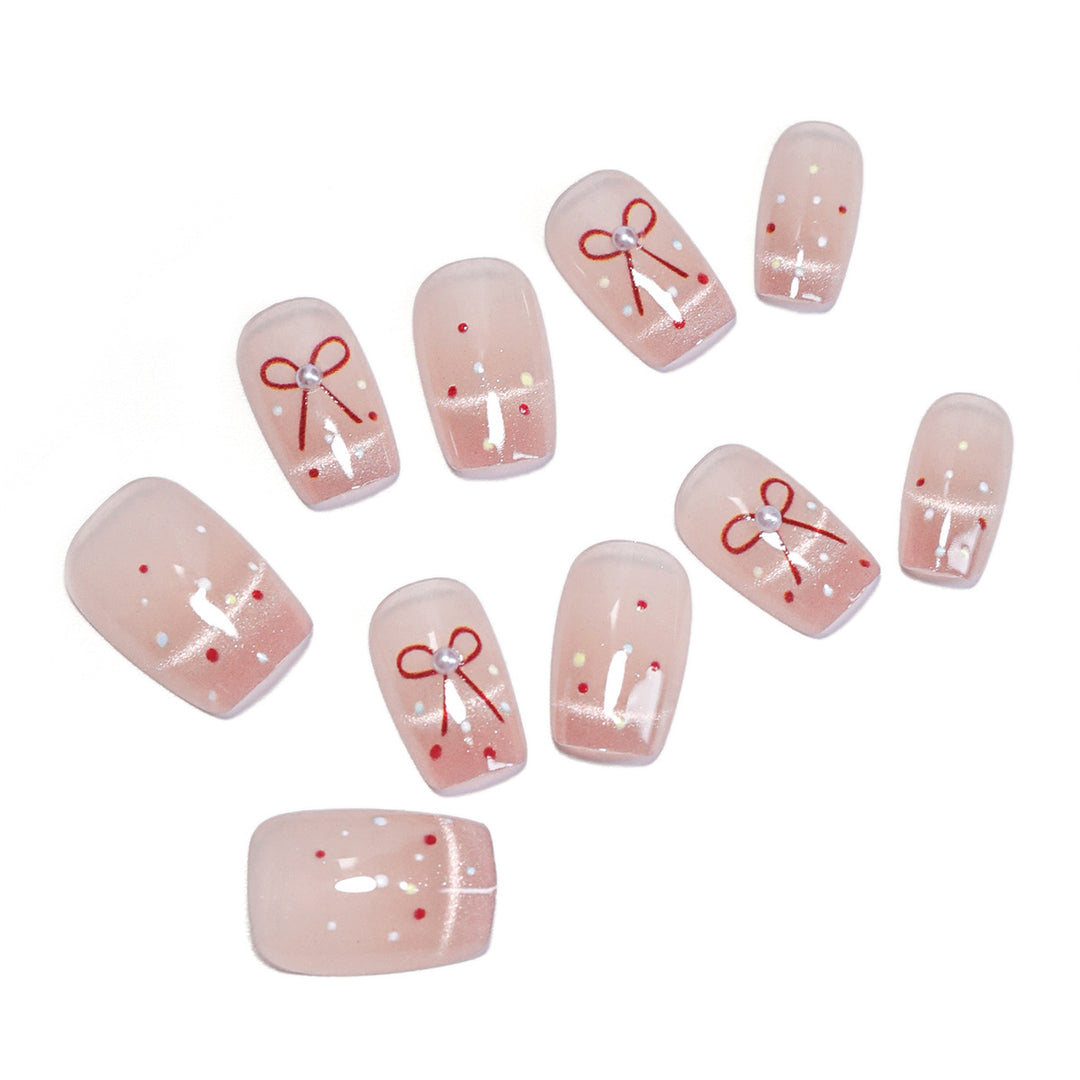 Artificial nail art with elegant bows and glitter accents Bowlift