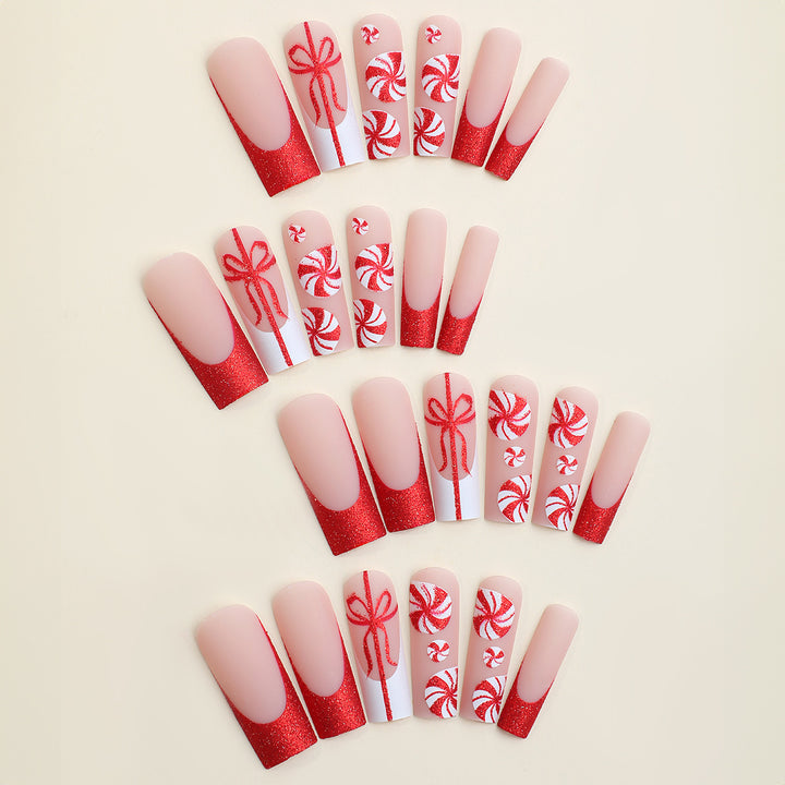 Artificial nail set with festive candy cane design and glitter accents Bowlift