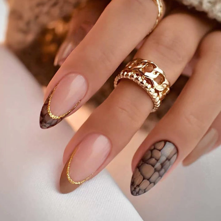 Artful stiletto nails with elegant gold decoration Bowlift