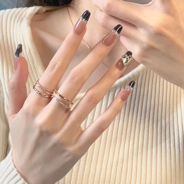 Glamorous artificial nails with heart design and glittering accents Bowlift