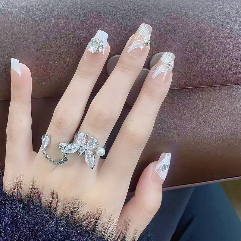 Elegant artificial nail set with delicate decorations and glitter elements Bowlift