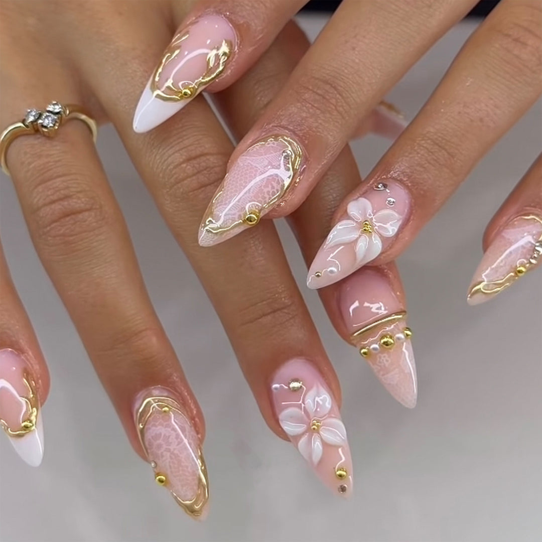 Artful nail extensions with delicate flower and gold embellishments Bowlift