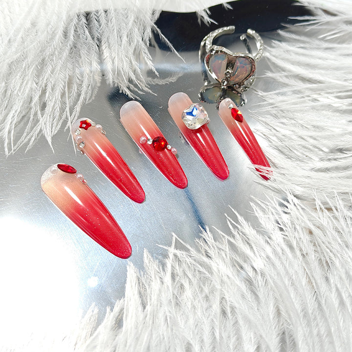 Artificial nails in elegant ombre style with glitter and jewelry accents Bowlift