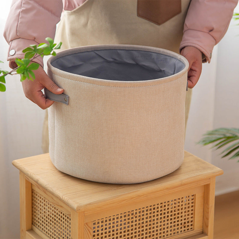 Organizer basket with practical handle and water-repellent inner coating
