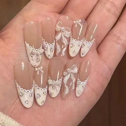 Artful nail art with elegant bows and rhinestone details Bowlift