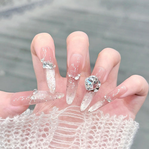 Artificial nails with glitter and crystal embellishments Bowlift