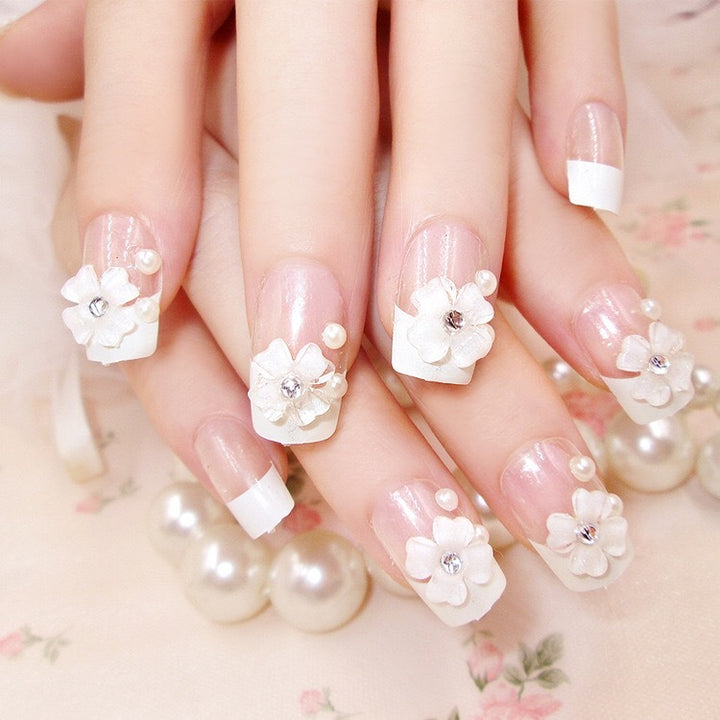 Artificials nails with sparkling rhinestone accents and elegant flower embellishments Bowlift