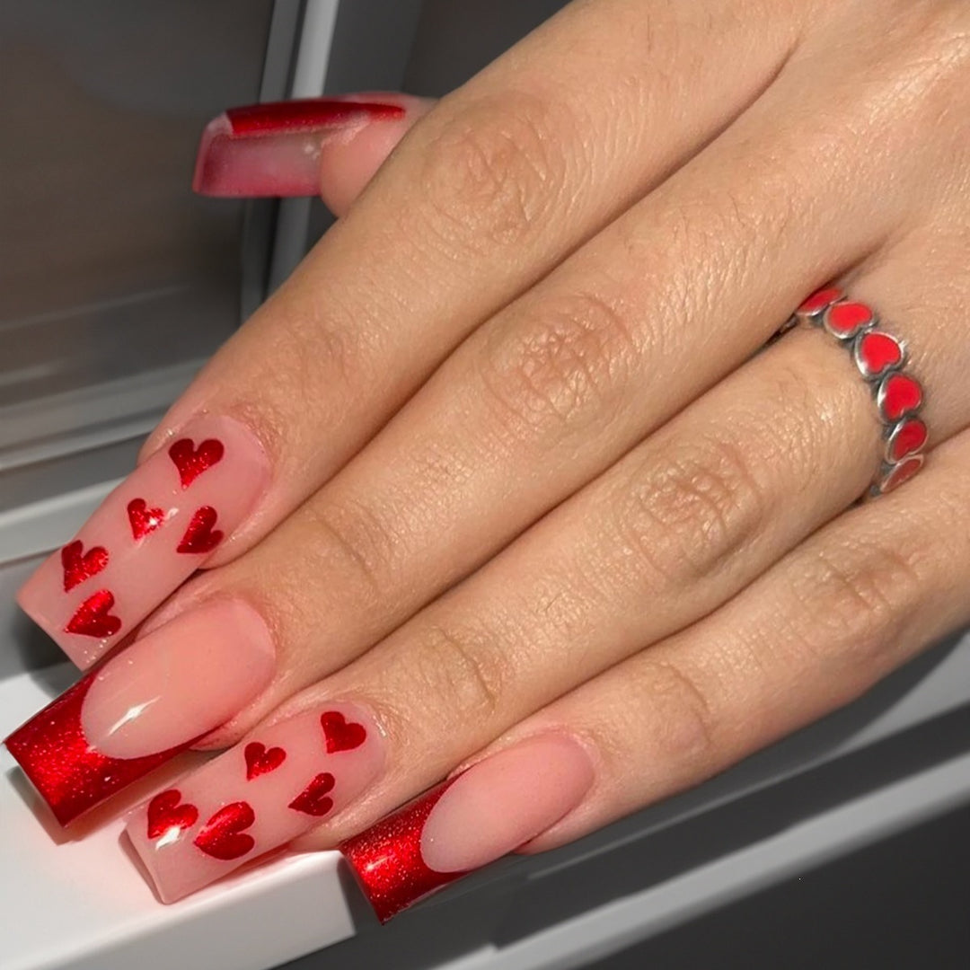 Acrylic nail set with glamorous heart designs and glitter accents Bowlift