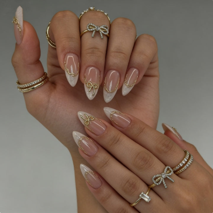 Artificial nails with elegant tip decorations and golden accents Bowlift