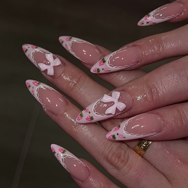 Artful stiletto nails with floral accents and bow embellishments Bowlift