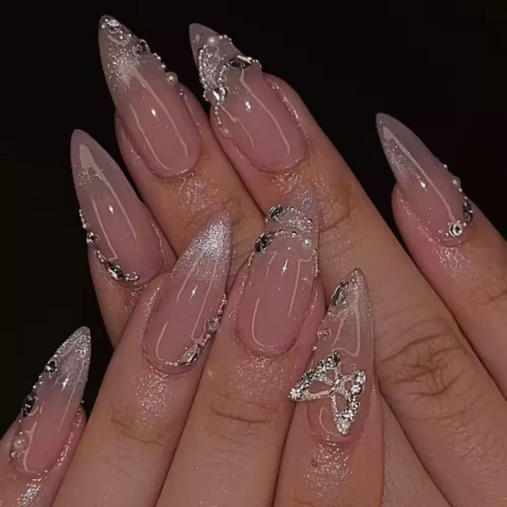Elegant Stiletto Nail Design with Rhinestone Embellishments Bowlift