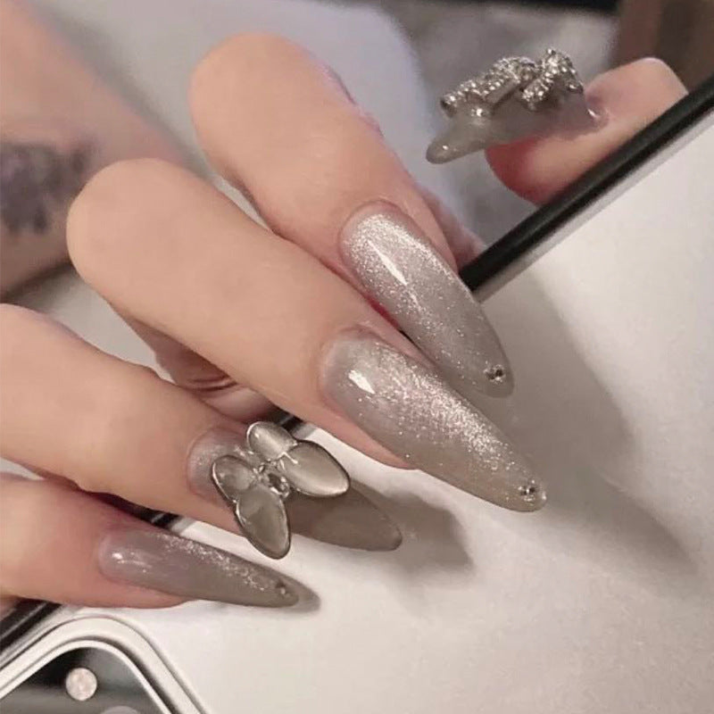 Glamorous stiletto nails with radiant glitter and elegant 3D design Bowlift