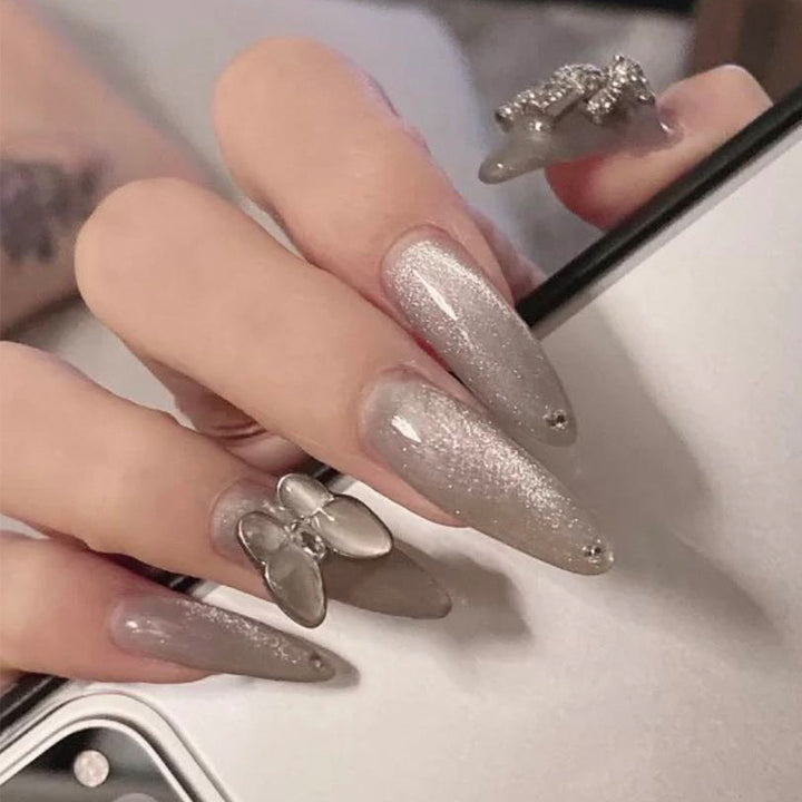 Glamorous stiletto nails with radiant glitter and elegant 3D design Bowlift