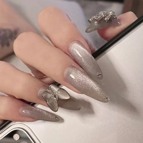 Glamorous stiletto nails with radiant glitter and elegant 3D design Bowlift