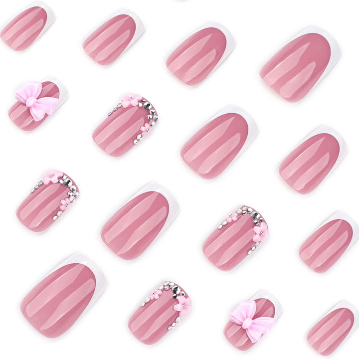 Artful nail extensions with sparkling accents and bow decorations Bowlift