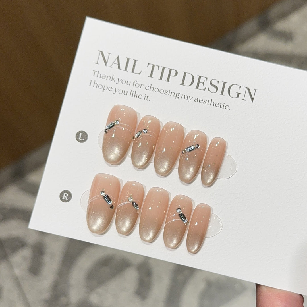 Artificial nail tips with elegant gradient color and rhinestone accents Bowlift