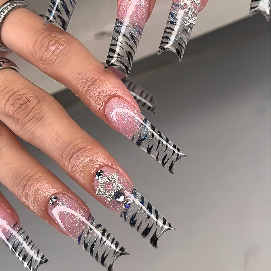 Artistic Stiletto Nail Enhancements with Glamorous Glitter Bowlift