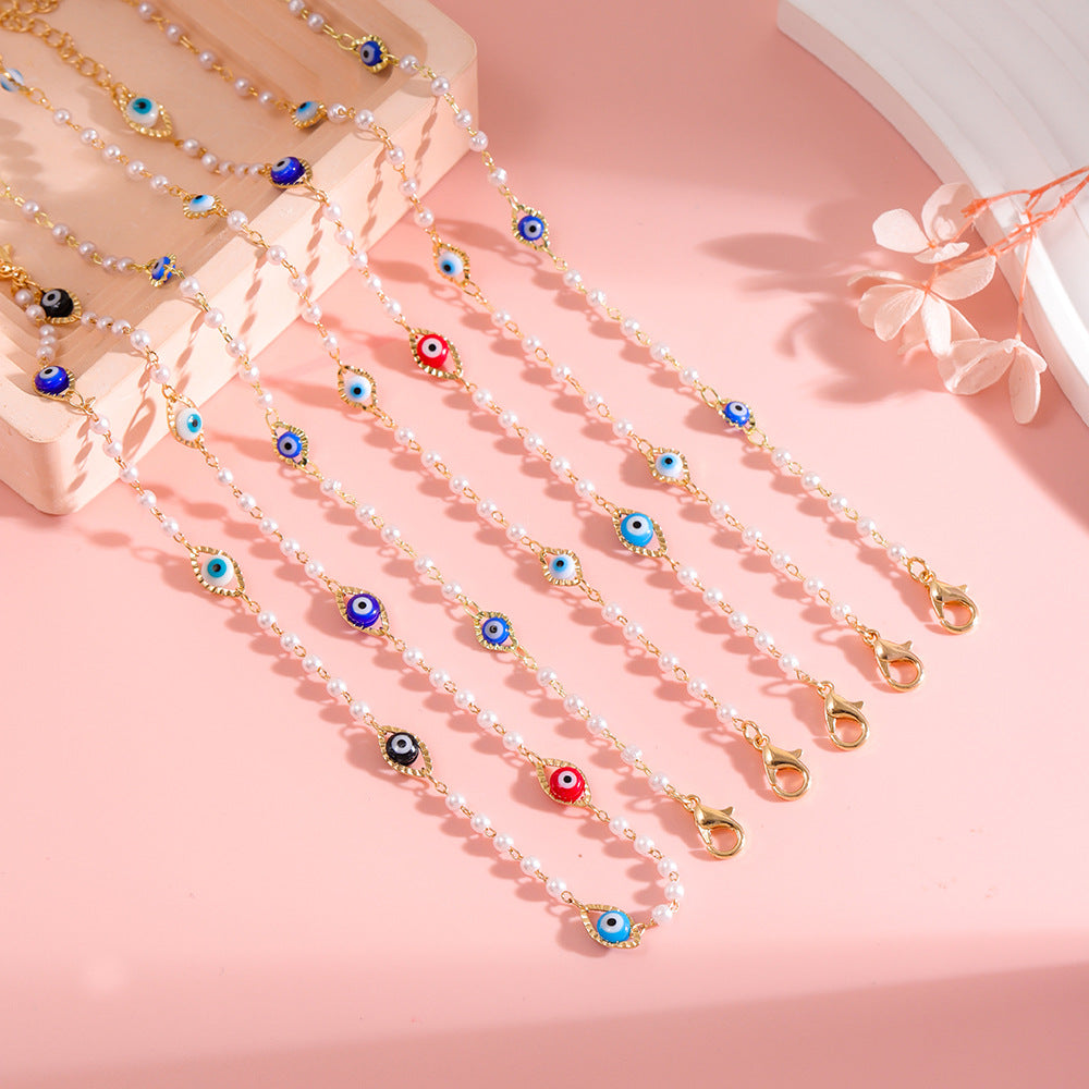 Elegant Pearl and Eye Charm Necklace Bowlift