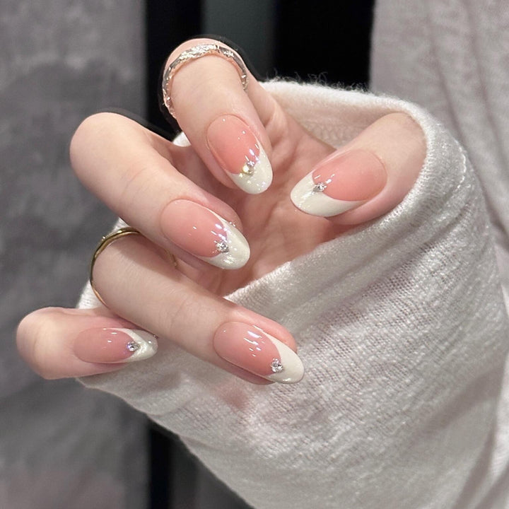 Artificial nails with elegant French style and sparkling accents Bowlift