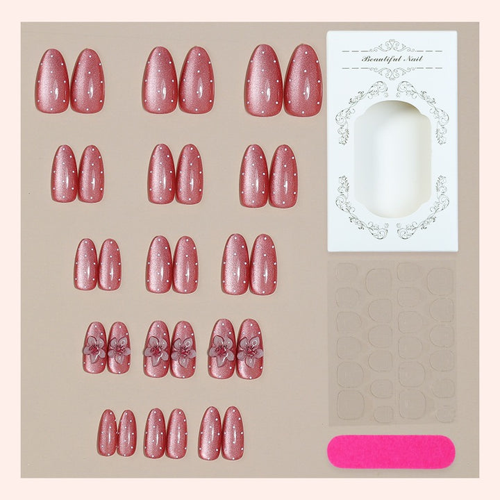 Artificial nail set with glamorous glitter design and floral accent Bowlift