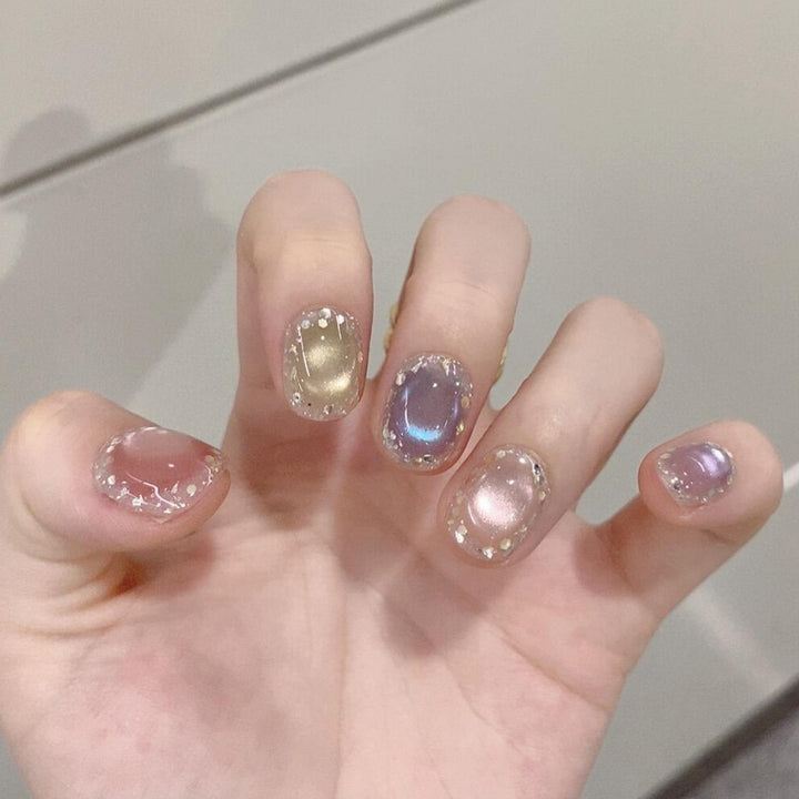 Artificial acrylic nails with shimmering effects and elegant glitter accents Bowlift