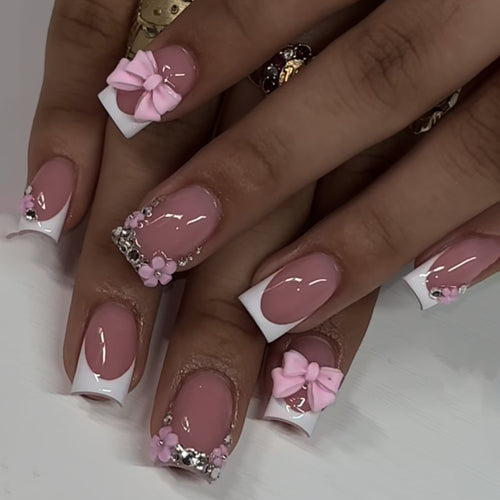 Artful nail extensions with sparkling accents and bow decorations Bowlift