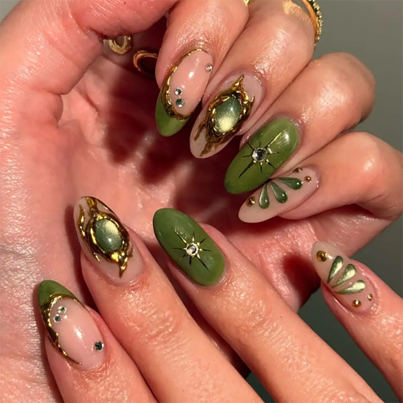 Artistic nail extensions with elegant gold and green shimmer Bowlift