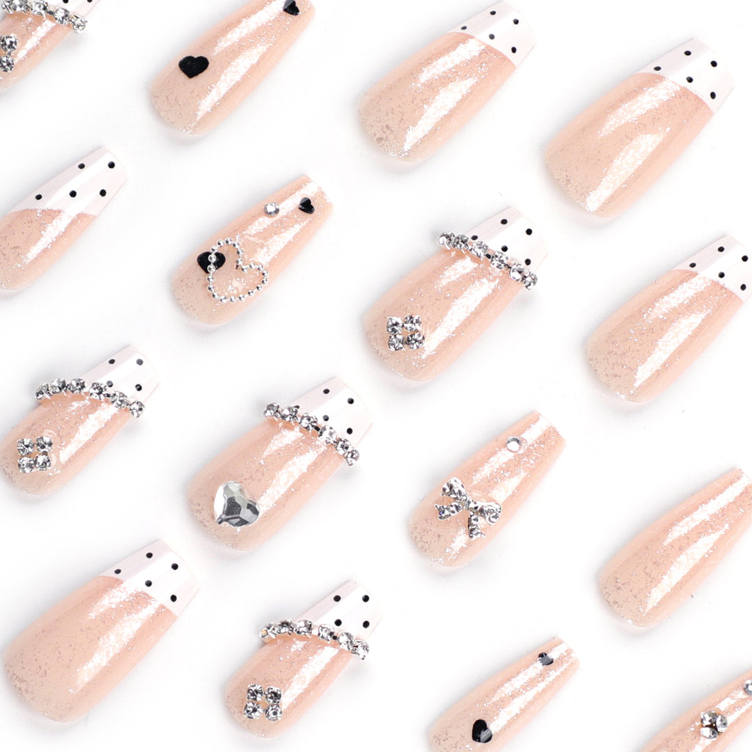 Artful nail extensions with elegant rhinestone and heart designs Bowlift
