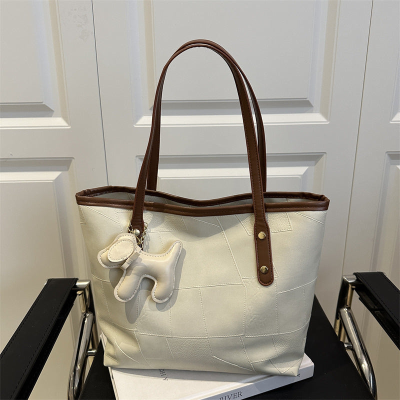 Stylish Textured Tote Bag with Decorative Charm