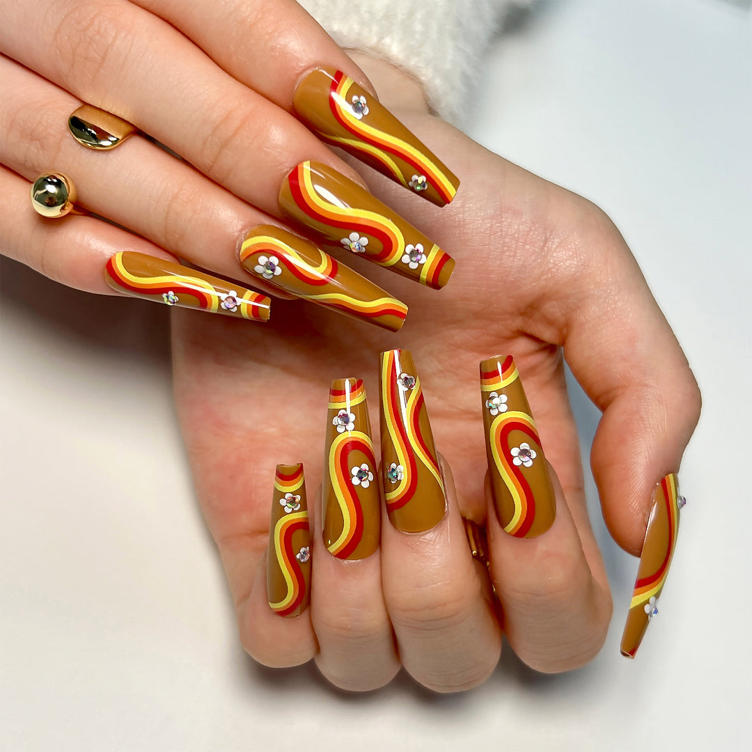 Artful acrylic nails with wave design and floral embellishments Bowlift