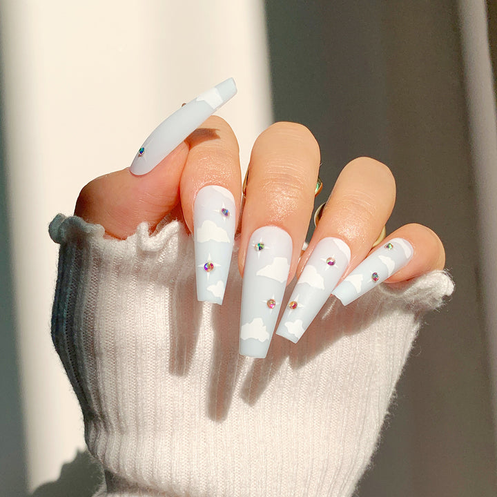 Creative nail art in cloud design with glitter accents Bowlift