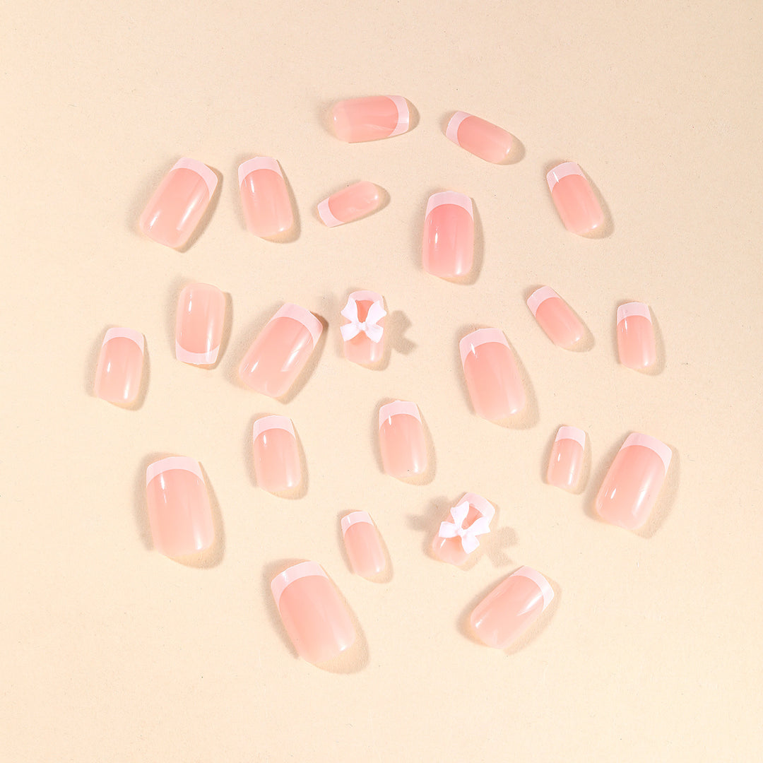 Elegant French Tip Nail Art with Bow Embellishments Bowlift