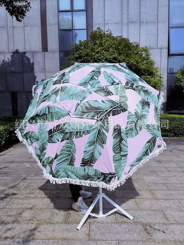 Ladies sun umbrella with tropical leaf design and tassel decoration Bowlift