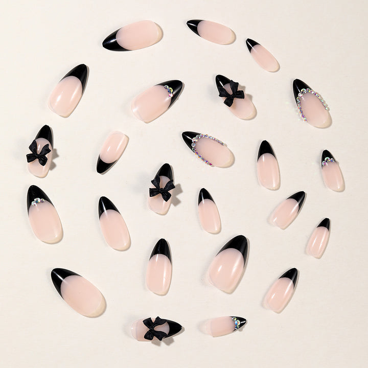 Elegant Stiletto Nail Design with Rhinestone Accents Bowlift