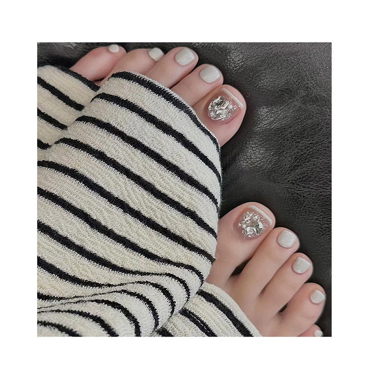 Artistic toenail art with rhinestone and glitter elements Bowlift