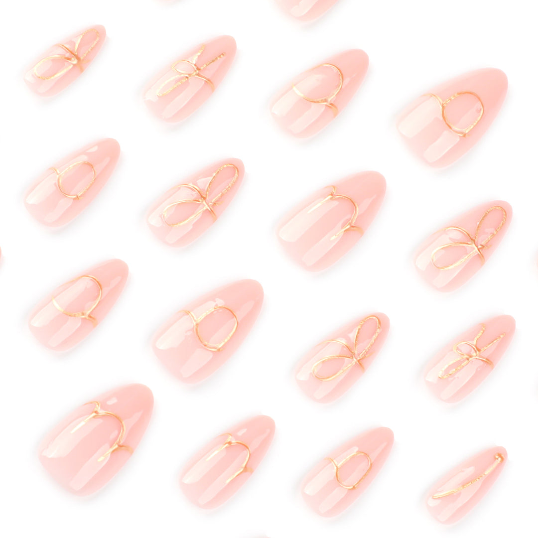 Creative nail art with golden accents and trendy lettering Bowlift