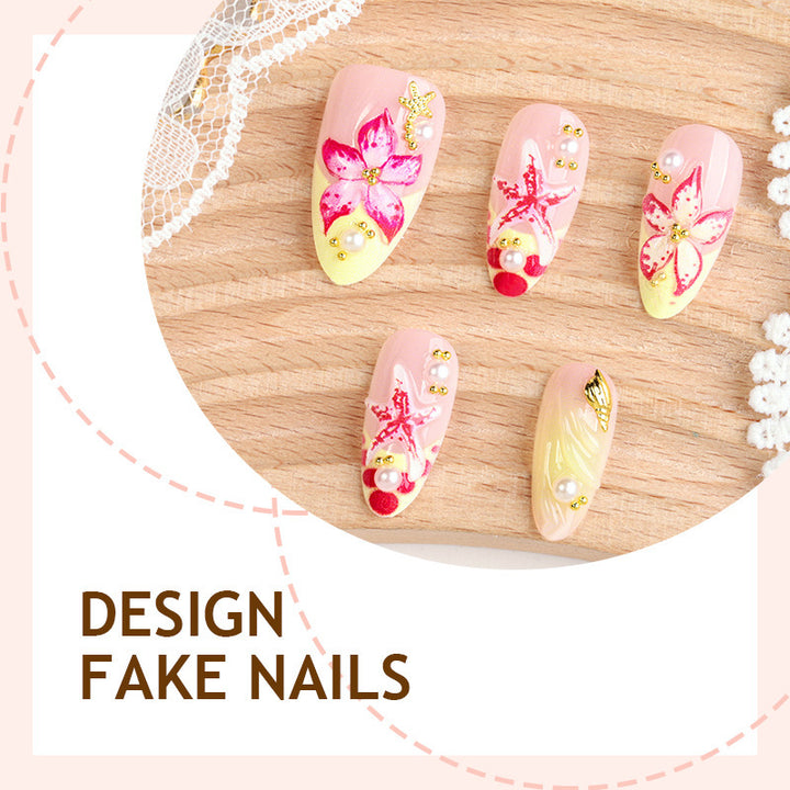 Artificial nail set with delicate floral decorations and glitter accents Bowlift