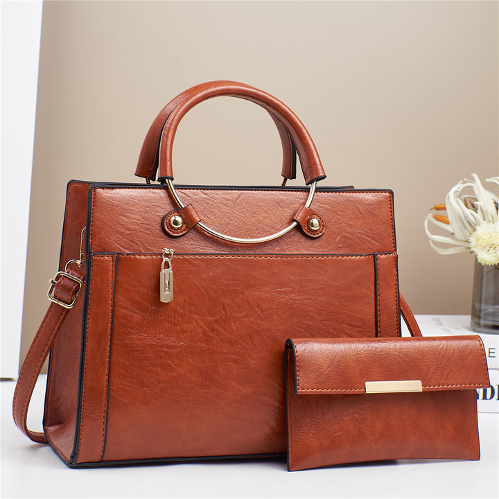 Elegant handbag with detachable shoulder strap and matching wallet Bowlift