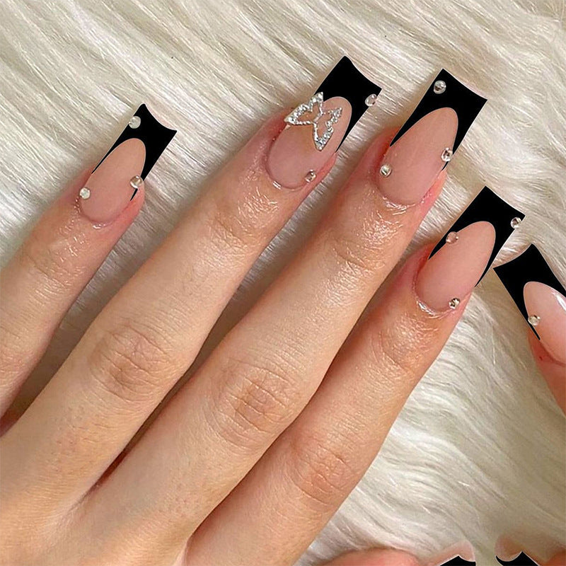 Acrylic nail set with elegant black and white design and glitter accents Bowlift