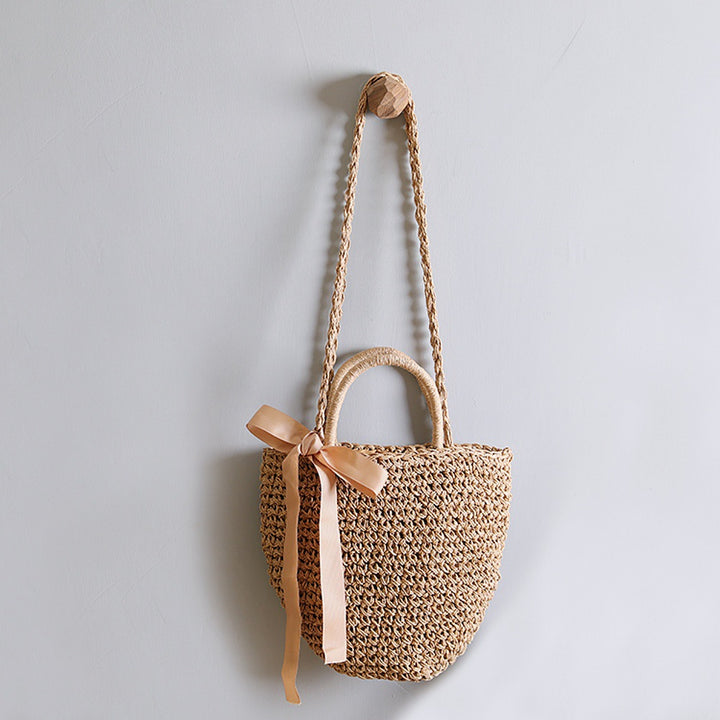 Basket bag with stylish carrying handles and decorative bow Bowlift