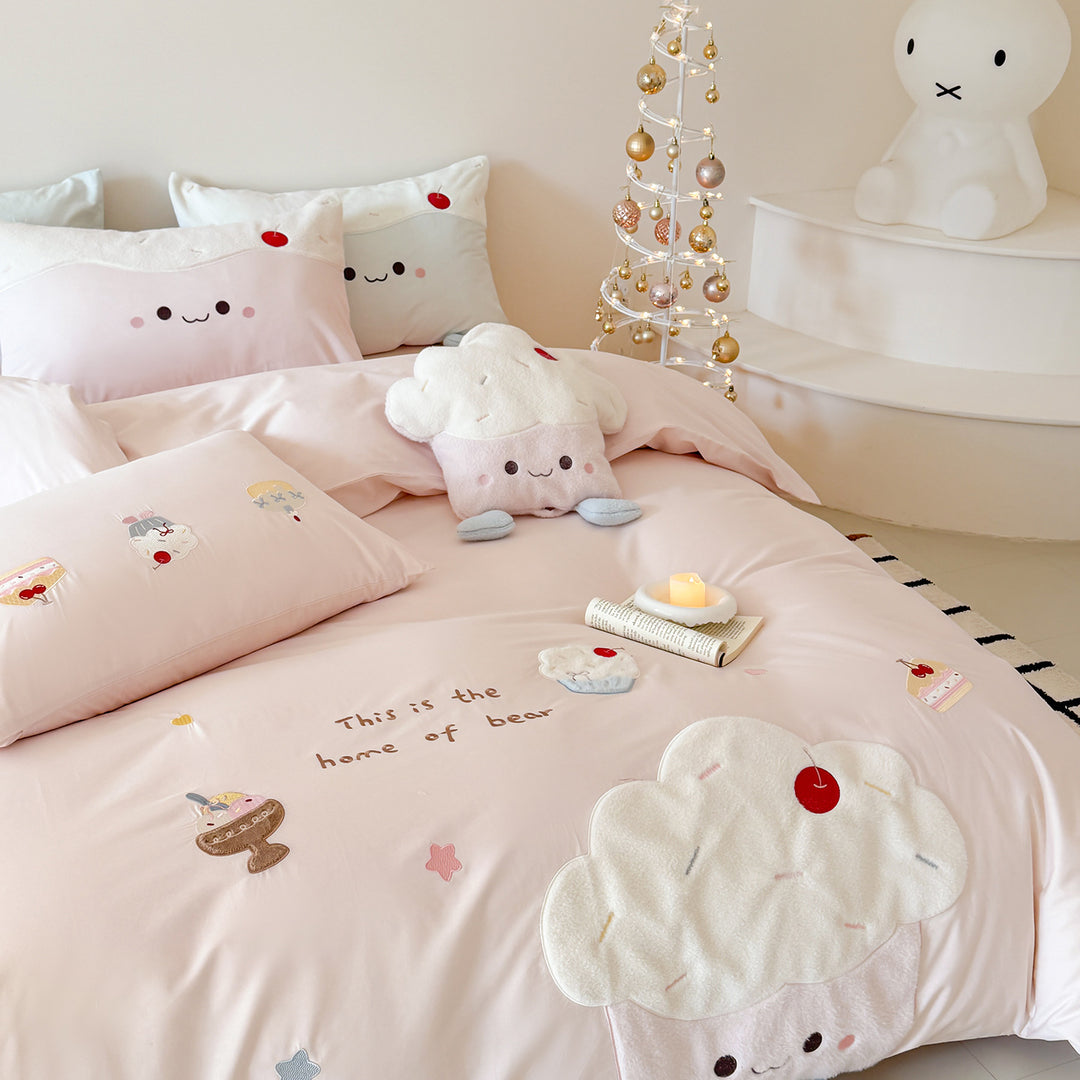 Children's bedding set with embroidered cupcake and cloud appliqués