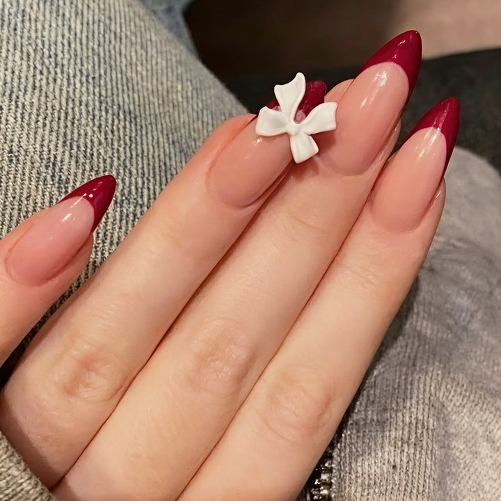 Acrylic nail set with creative French tip design and cute bows Bowlift
