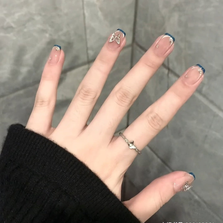 Artificial nails with trendy French tips and decorative glitter accents Bowlift