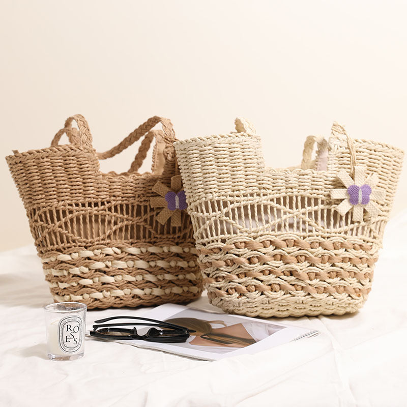 Braided basket bag with decorative flower appliqué Bowlift