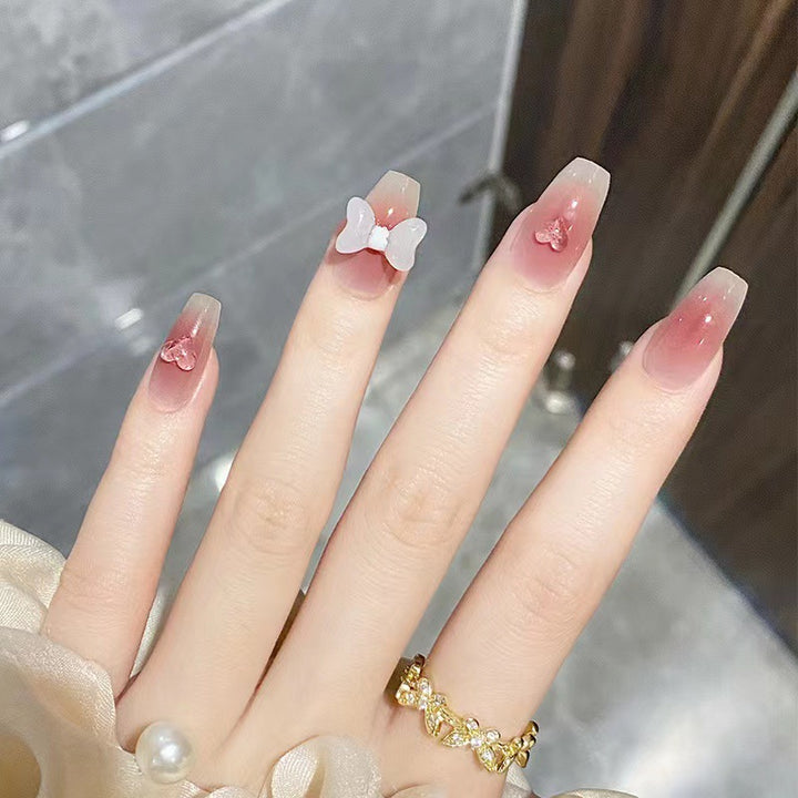 Artful acrylic nails with heart and bow design Bowlift