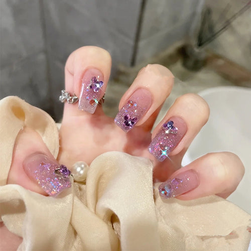 Glamorous artificial nails with glitter and floral accents Bowlift