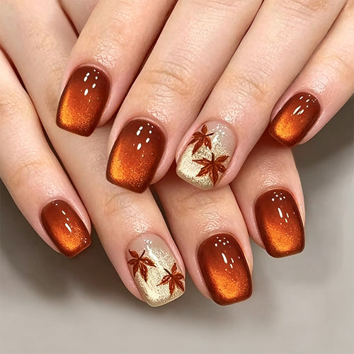 Artificial nails with glamorous ombre design and autumn leaf applications Bowlift